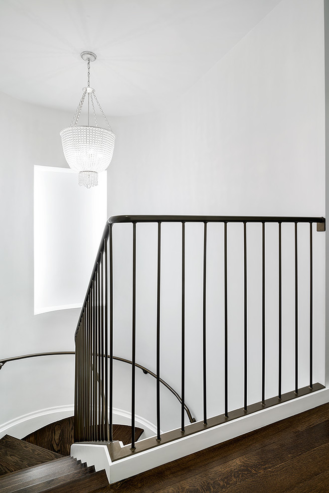 Photo of a transitional curved staircase in New York.