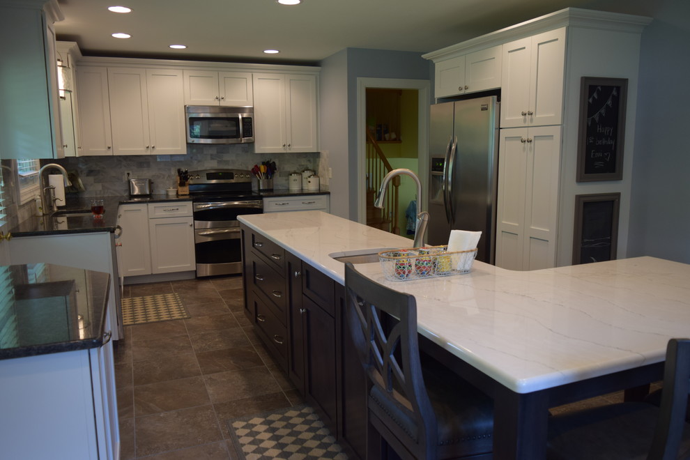 Large elegant l-shaped terra-cotta tile kitchen photo with shaker cabinets, white cabinets, quartz countertops, blue backsplash, porcelain backsplash, stainless steel appliances and an island