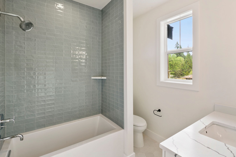 Inspiration for a mid-sized bathroom in Seattle with white cabinets, a shower/bathtub combo, a one-piece toilet, gray tile, glass sheet wall, white walls, cement tiles, an undermount sink, engineered quartz benchtops, white floor, an open shower, white benchtops, a single vanity and a built-in vanity.