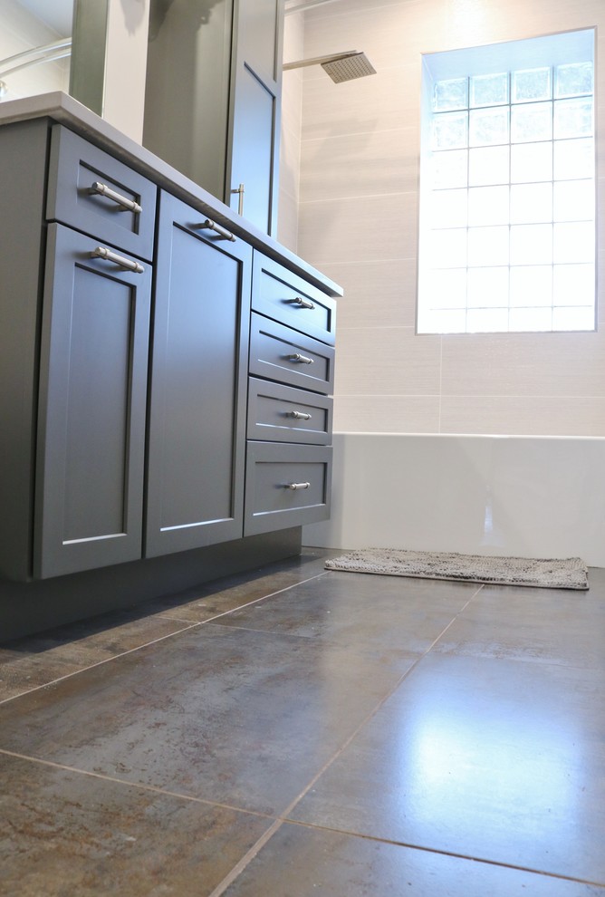 Example of a mid-sized transitional 3/4 beige tile and ceramic tile ceramic tile and gray floor home design design in Chicago with shaker cabinets, gray cabinets, a one-piece toilet, gray walls, an undermount sink, quartz countertops and gray countertops