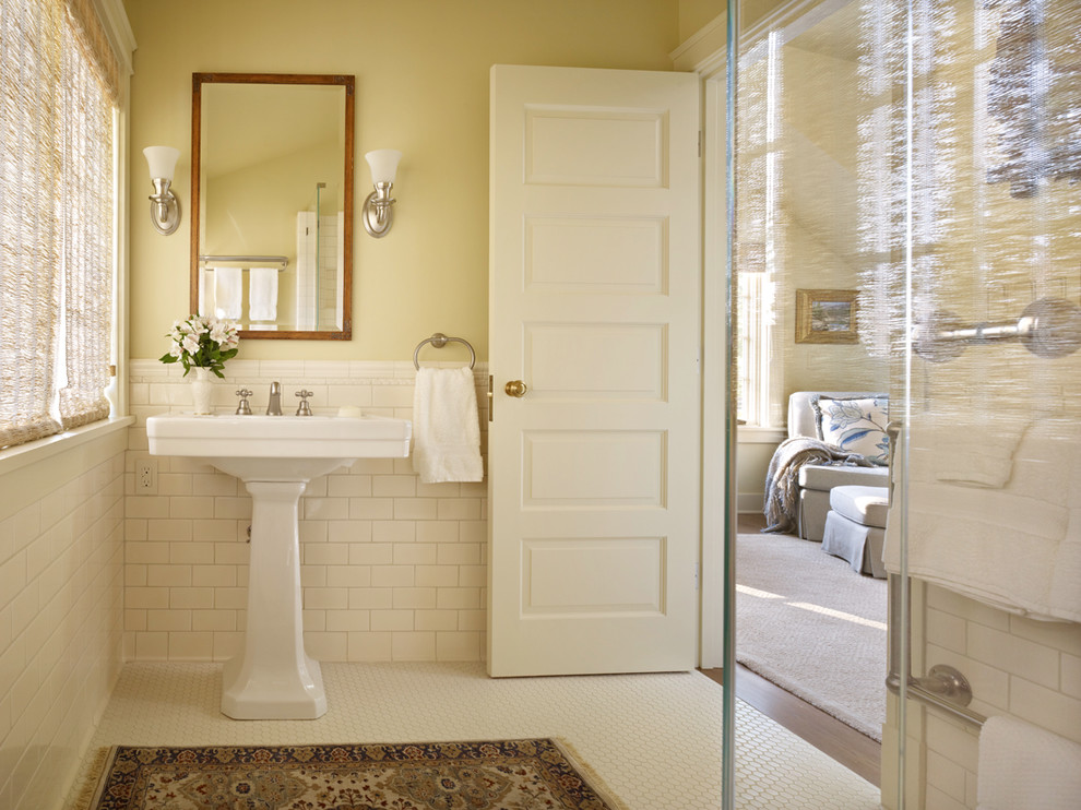 Design ideas for a traditional bathroom in Seattle with a pedestal sink, a corner shower, yellow walls and mosaic tile floors.