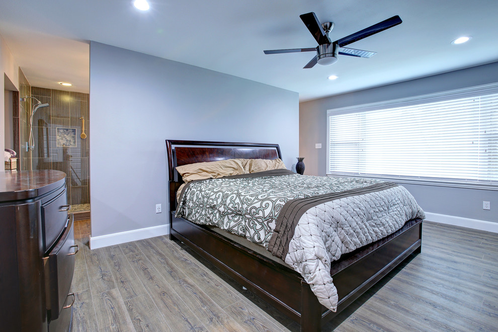 Photo of a large traditional master bedroom in Houston with grey walls, dark hardwood floors and brown floor.