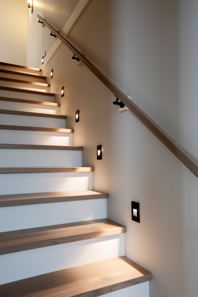 Modern wood straight staircase in Vancouver with wood railing.