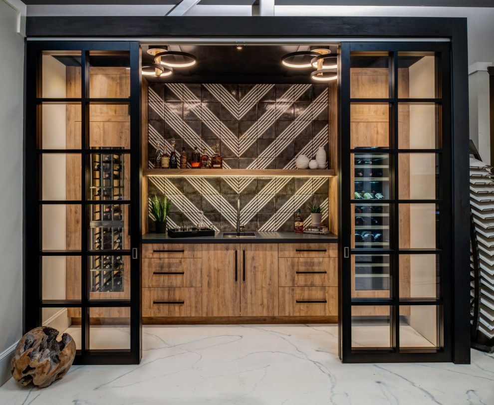 Inspiration for a mid-sized transitional single-wall wet bar in Other with an undermount sink, flat-panel cabinets, light wood cabinets, concrete benchtops, black splashback, porcelain splashback, concrete floors, white floor and black benchtop.