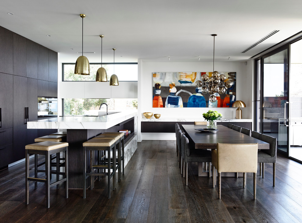 Design ideas for a contemporary galley open plan kitchen in Melbourne with flat-panel cabinets, black cabinets, marble benchtops, panelled appliances, dark hardwood floors and with island.