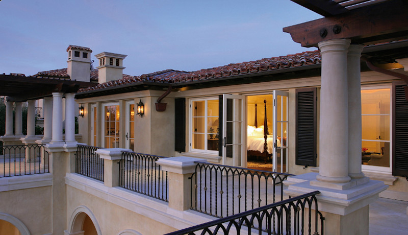 This is an example of a mediterranean two-storey concrete beige exterior in Orange County.
