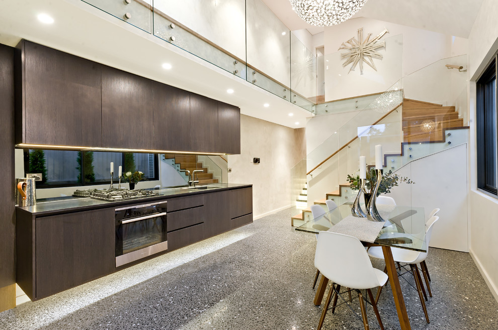 Contemporary single-wall eat-in kitchen in Sydney with a drop-in sink, flat-panel cabinets, dark wood cabinets, mirror splashback, stainless steel appliances and no island.