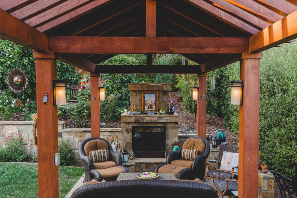 Inspiration for a small asian backyard patio in Santa Barbara with with fireplace, concrete pavers and a pergola.