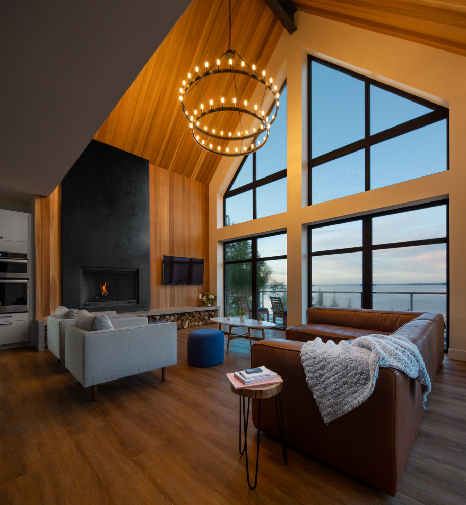 This is an example of a contemporary open concept living room in Calgary with brown walls, medium hardwood floors, a standard fireplace, a wall-mounted tv, brown floor, vaulted, wood and wood walls.
