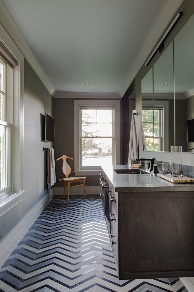 Mid-sized transitional ceramic tile and blue floor bathroom photo with flat-panel cabinets, brown cabinets, an undermount sink, marble countertops and brown countertops