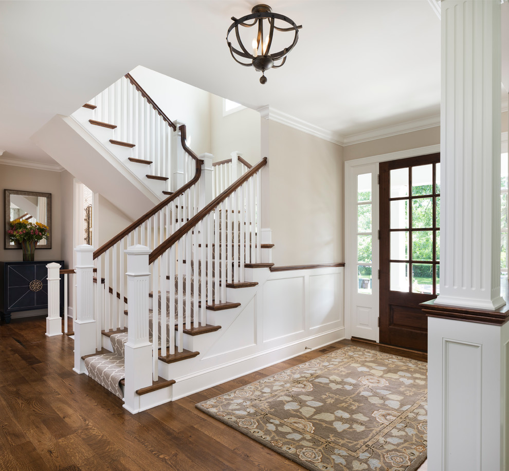Photo of a transitional wood u-shaped staircase in Minneapolis with painted wood risers.