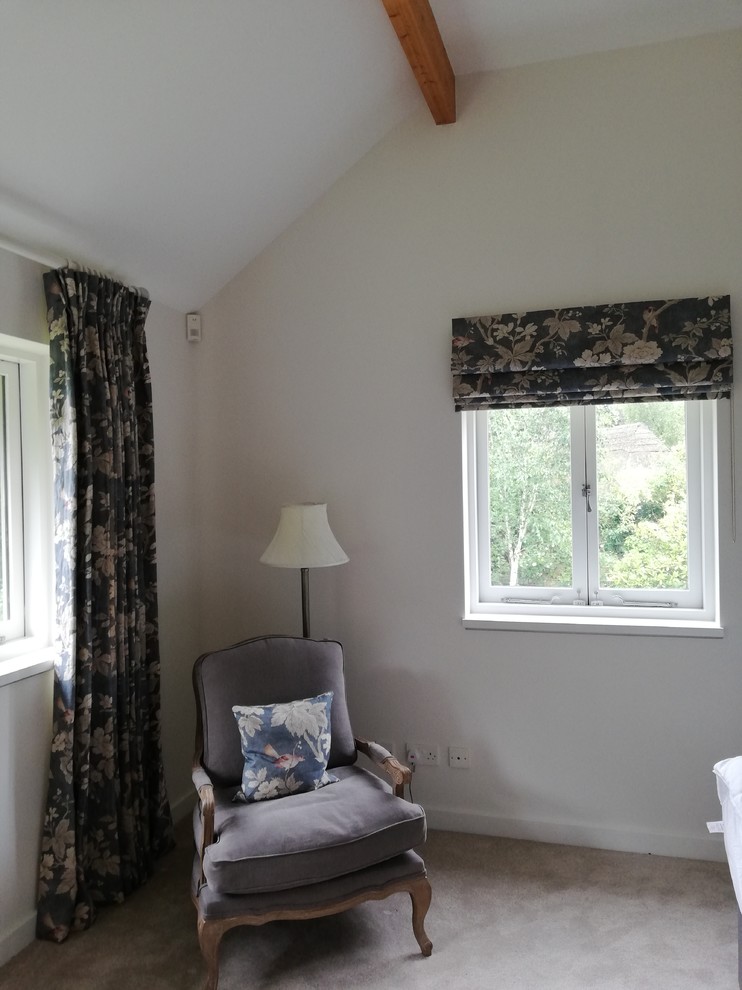 Photo of a mid-sized traditional master bedroom in Hampshire with white walls, carpet, no fireplace and grey floor.