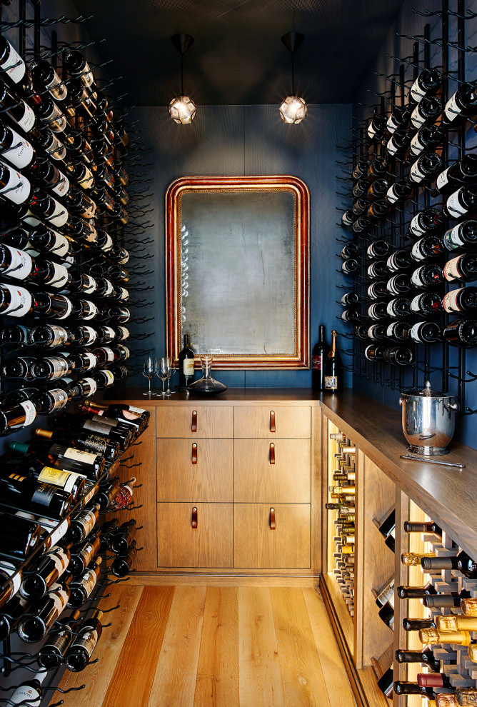 Design ideas for a beach style wine cellar in San Francisco with light hardwood floors and storage racks.