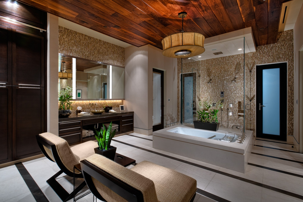 Inspiration for a contemporary bathroom in Las Vegas with a vessel sink, flat-panel cabinets, dark wood cabinets, a freestanding tub, a double shower and brown tile.