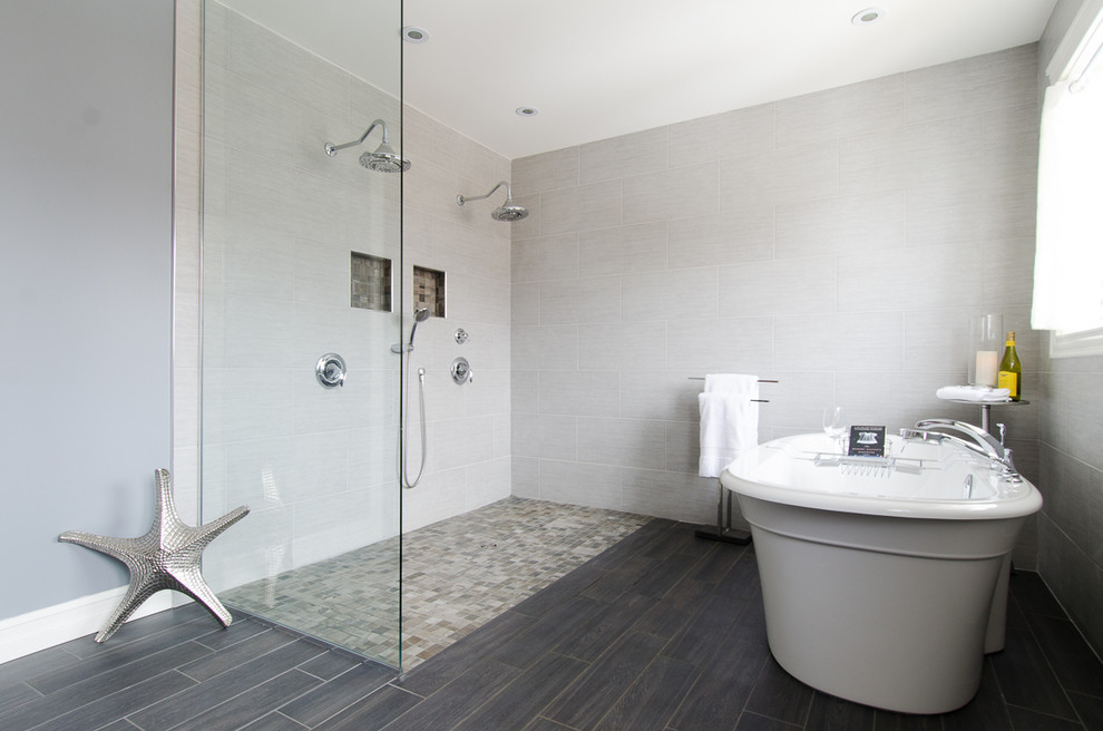 Design ideas for a large contemporary master bathroom in Calgary with a freestanding tub, a curbless shower, gray tile, porcelain tile, grey walls, porcelain floors, grey floor and an open shower.