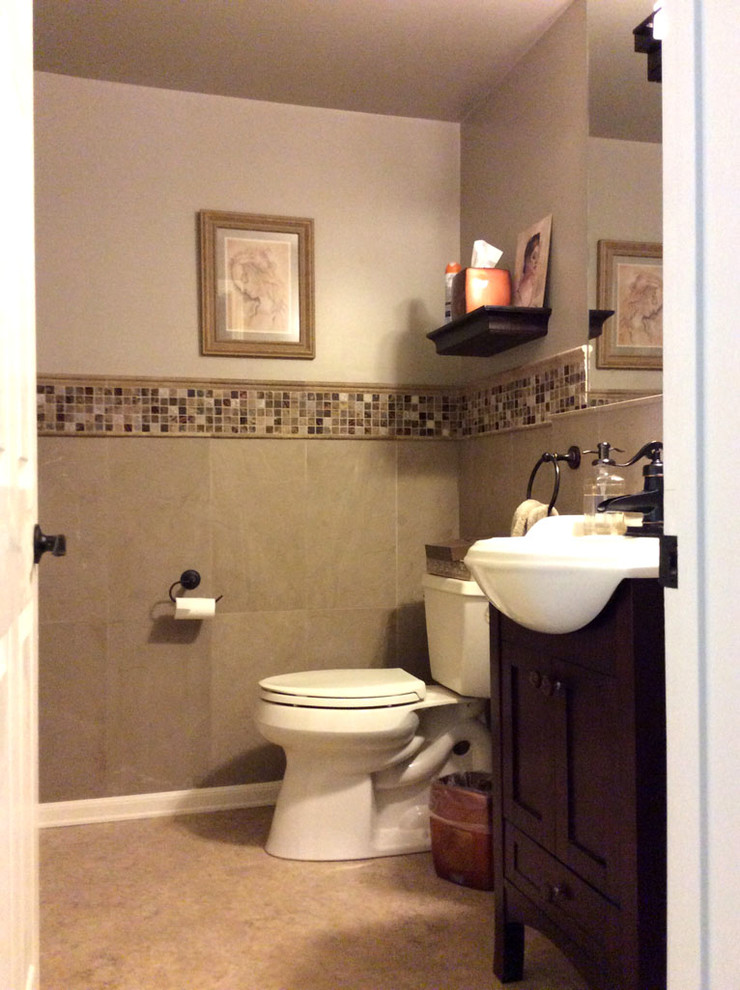 Photo of a mediterranean powder room in Los Angeles with an integrated sink, furniture-like cabinets, a two-piece toilet, stone tile and brown walls.