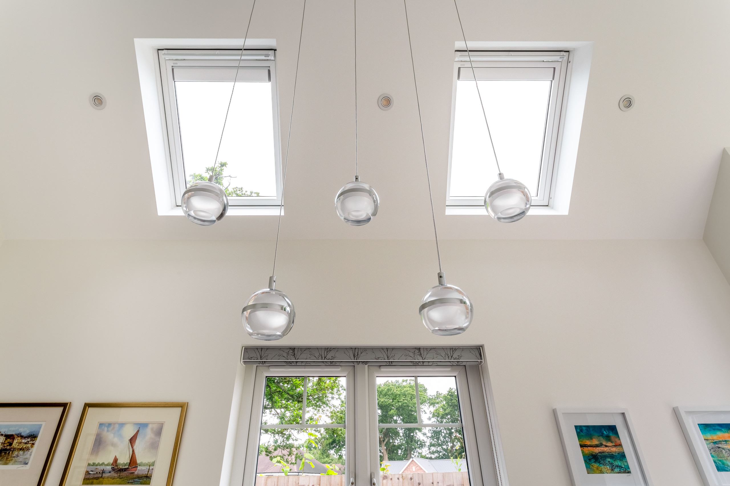 View of roof window, feature lighting and vaulted ceiling