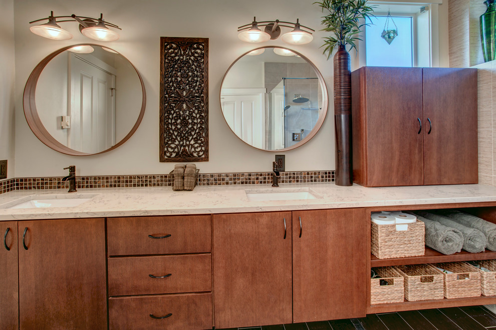 This is an example of a mid-sized asian master bathroom in Seattle with flat-panel cabinets, medium wood cabinets, a curbless shower, a wall-mount toilet, brown tile, porcelain tile, white walls, porcelain floors, an undermount sink and engineered quartz benchtops.