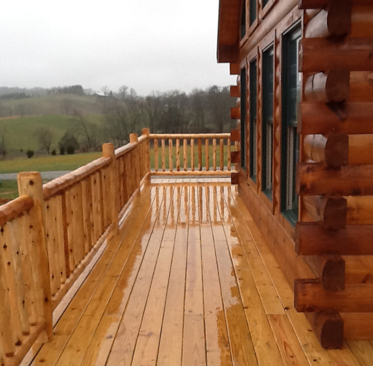 Deck - large rustic side yard balcony deck idea with a roof extension