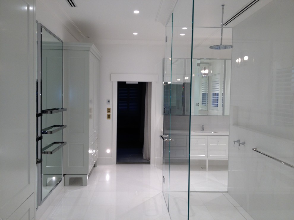 This is an example of an expansive modern master bathroom in Melbourne with recessed-panel cabinets.
