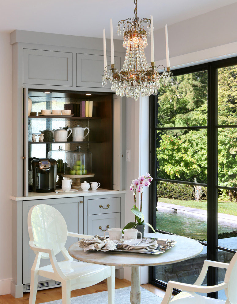 Mid-sized country light wood floor and brown floor eat-in kitchen photo with recessed-panel cabinets, gray cabinets and an island