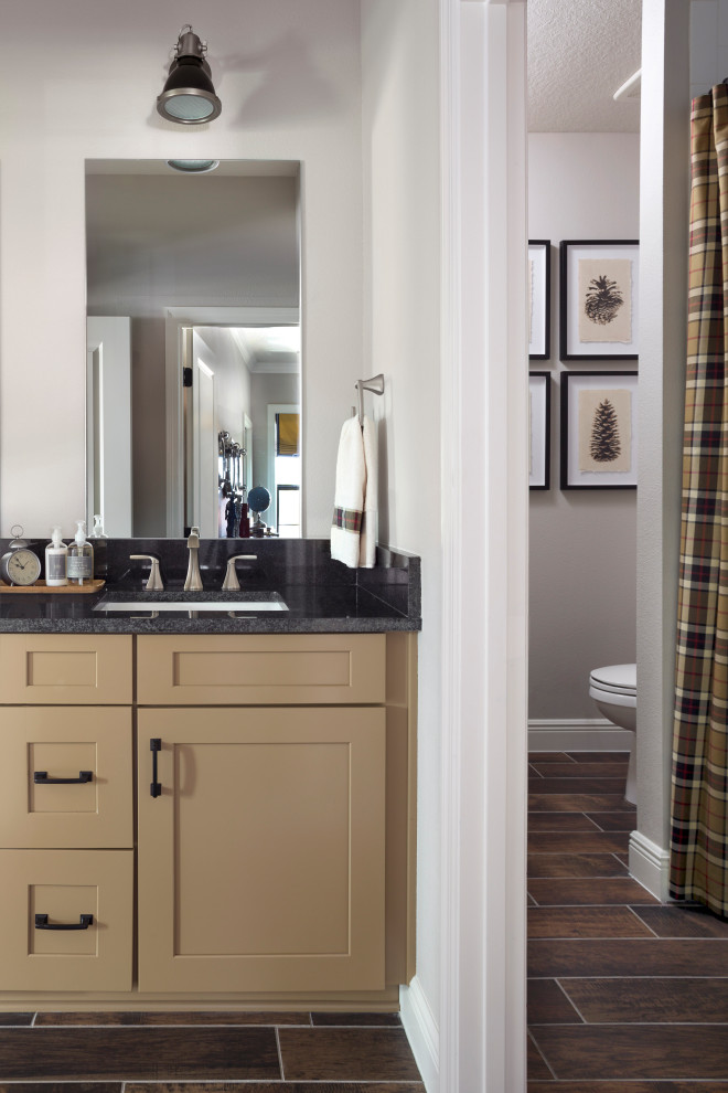 Nature Inspired Boys' Bath - A plaid shower curtain in tan, chocolate brown, and red sets the tone for this boys' bathroom.  Blackened stainless steel wall lights top each mirror in the double vanity.  Framed vintage acorn artwork and the painted cabinet add a rustic vibe to the space.
