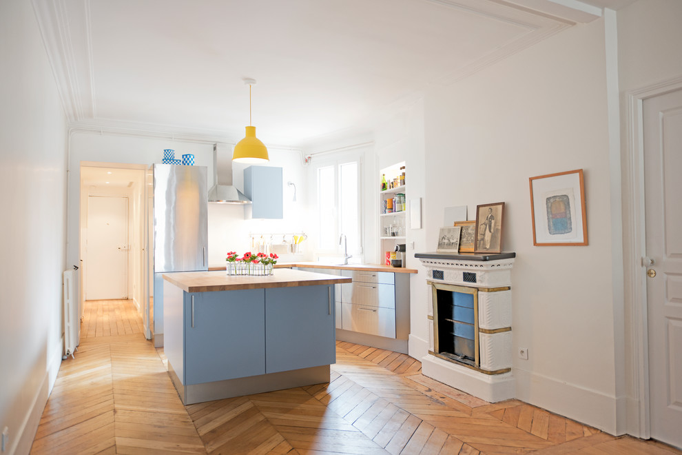 Design ideas for a large contemporary l-shaped open plan kitchen in Paris with stainless steel cabinets and with island.