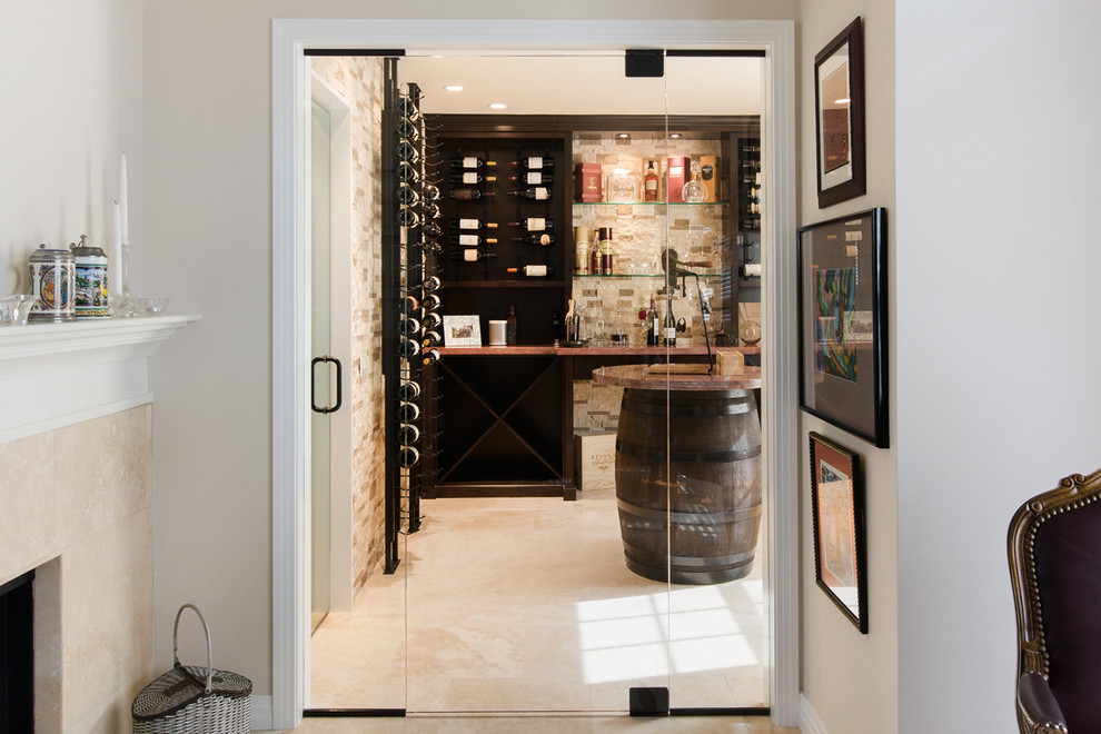 This is an example of a mediterranean wine cellar in Orange County with storage racks.
