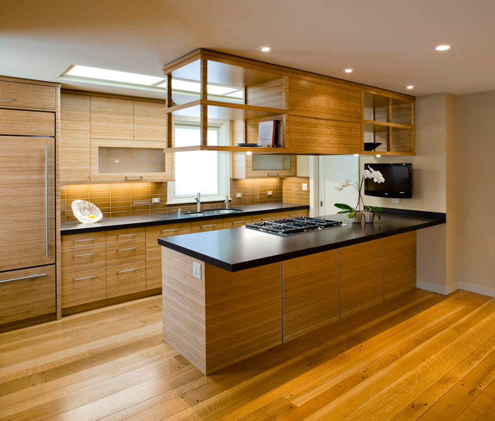 Photo of a mid-sized asian galley separate kitchen in San Francisco with an undermount sink, flat-panel cabinets, medium wood cabinets, brown splashback, stainless steel appliances, medium hardwood floors, quartz benchtops and porcelain splashback.