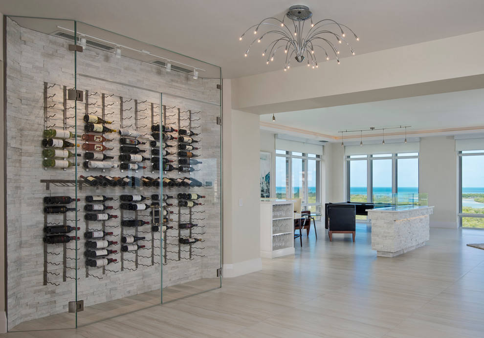 Small contemporary wine cellar in Miami with travertine floors and storage racks.