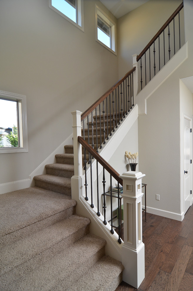 Design ideas for a large traditional carpeted u-shaped staircase in Portland with carpet risers.