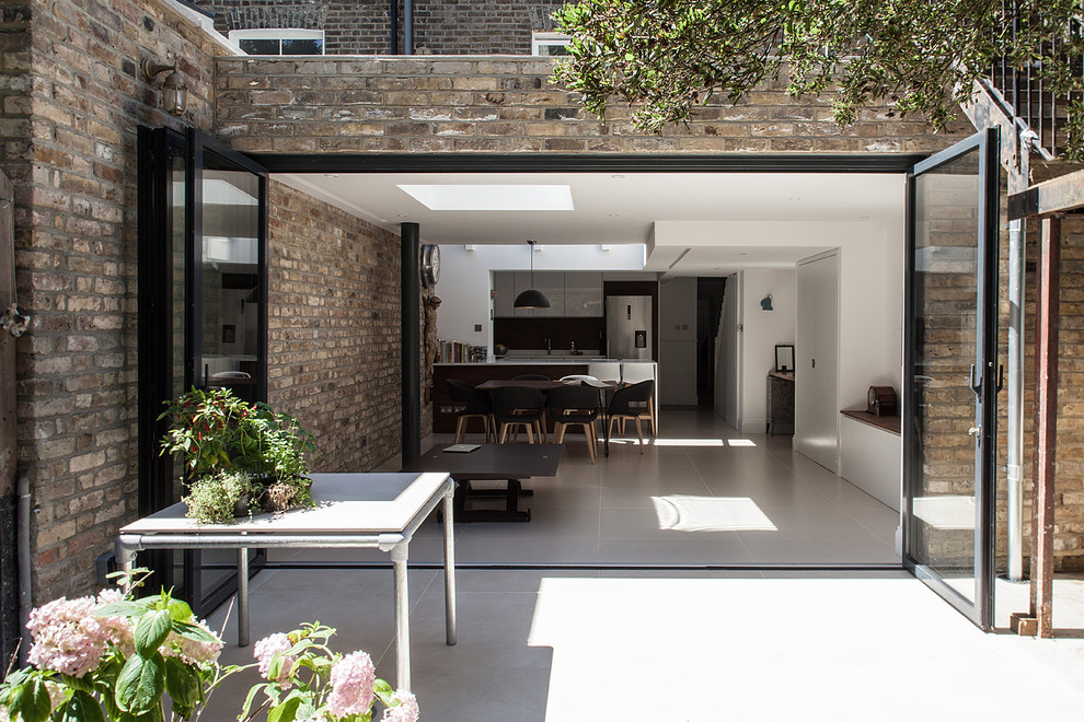 This is an example of a contemporary backyard patio in London.