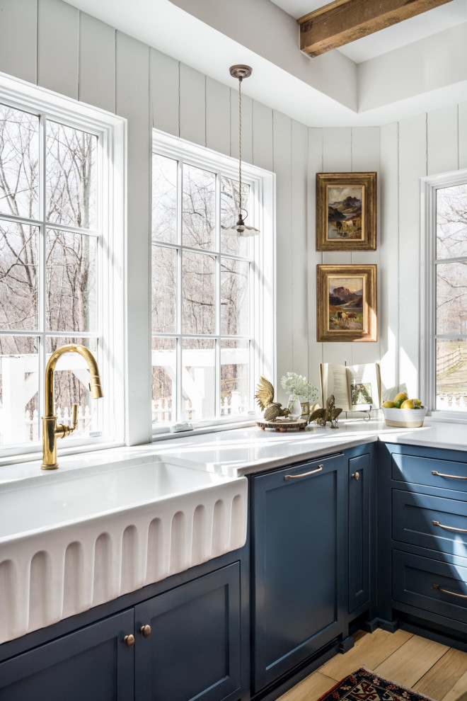 Inspiration for a mid-sized country u-shaped separate kitchen in Nashville with a farmhouse sink, beaded inset cabinets, blue cabinets, quartz benchtops, white splashback, timber splashback, stainless steel appliances, light hardwood floors, with island, yellow floor and white benchtop.
