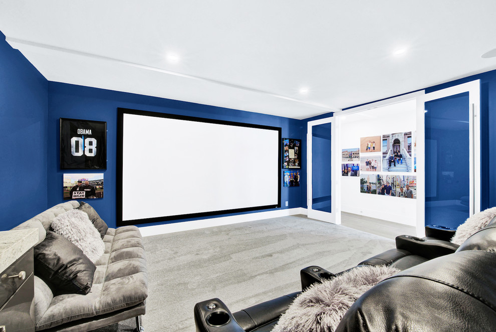 Mid-sized contemporary enclosed home theatre in San Francisco with blue walls, carpet, a projector screen and beige floor.