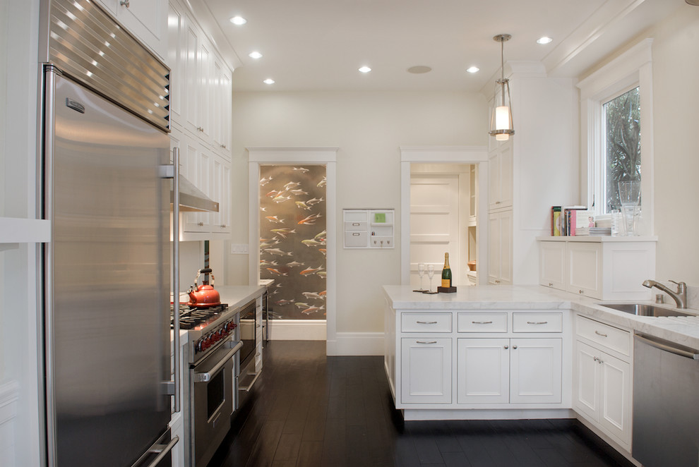 Inspiration for a contemporary u-shaped separate kitchen in San Francisco with stainless steel appliances, marble benchtops, an undermount sink, recessed-panel cabinets and white cabinets.