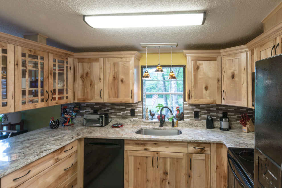 Inspiration for a mid-sized u-shaped cement tile floor and beige floor eat-in kitchen remodel with an undermount sink, shaker cabinets, light wood cabinets, granite countertops, glass tile backsplash, black appliances, a peninsula and beige countertops