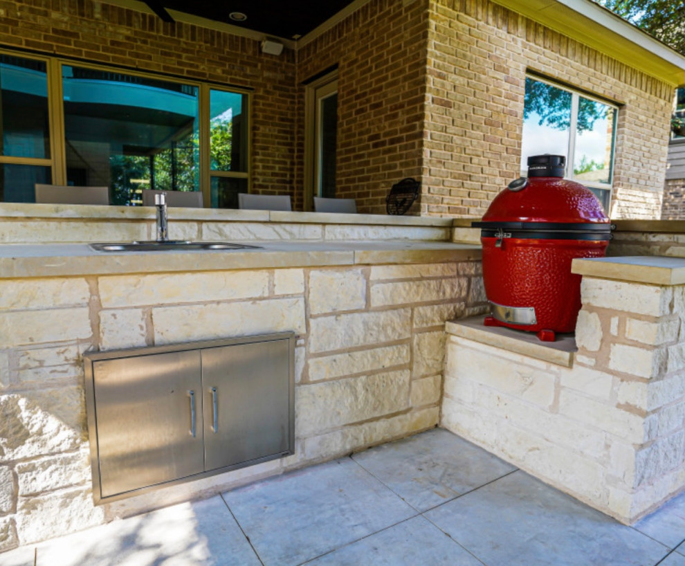 Photo of a small traditional back fully shaded garden for summer in Austin with a fireplace and natural stone paving.
