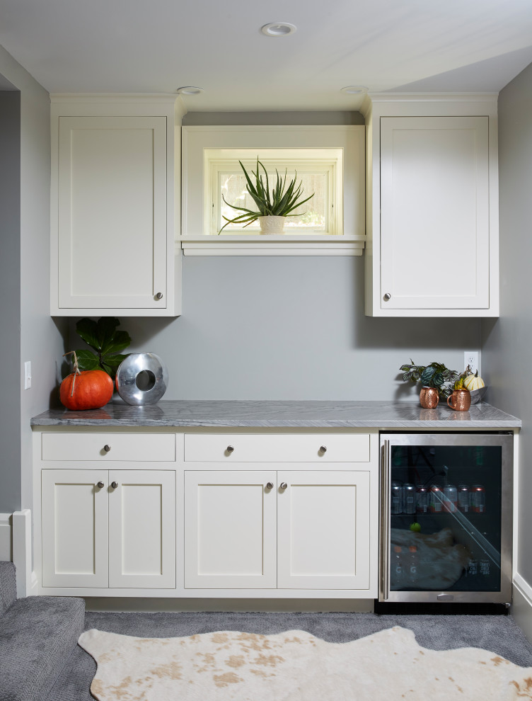 This is an example of a traditional single-wall dry bar in Minneapolis with carpet, grey floors, no sink, shaker cabinets, white cabinets, grey splashback and grey worktops.