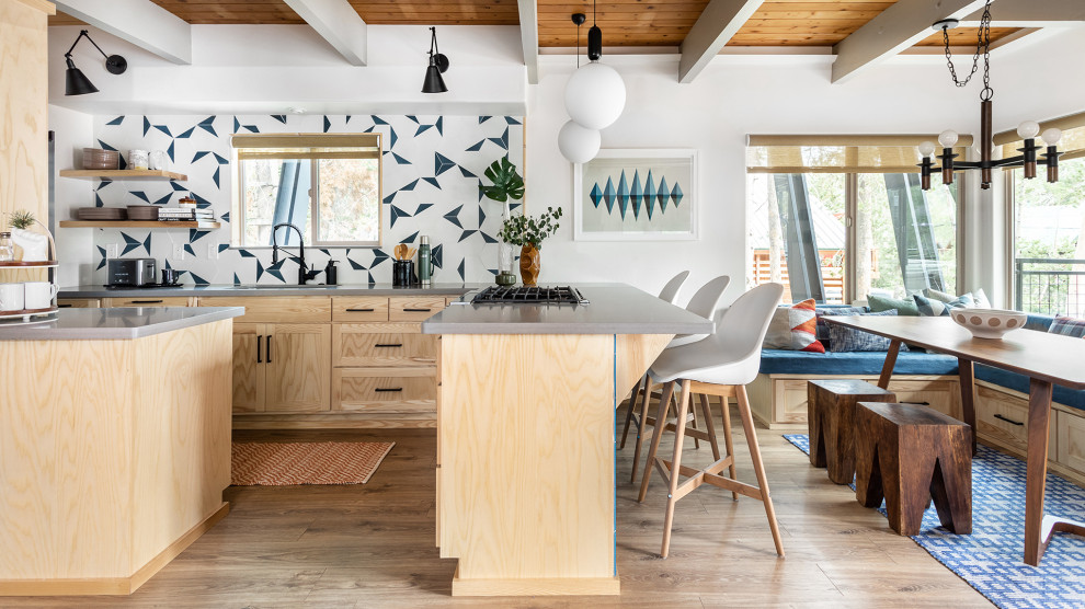This is an example of a large rustic l-shaped kitchen/diner in Other with a submerged sink, shaker cabinets, light wood cabinets, quartz worktops, blue splashback, ceramic splashback, black appliances, laminate floors, a breakfast bar, beige floors, grey worktops and exposed beams.