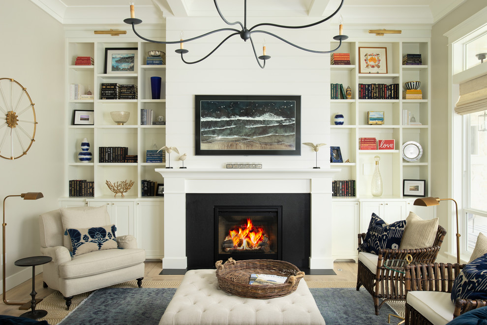 Beach style family room in Boise with a library, beige walls, light hardwood floors and a standard fireplace.