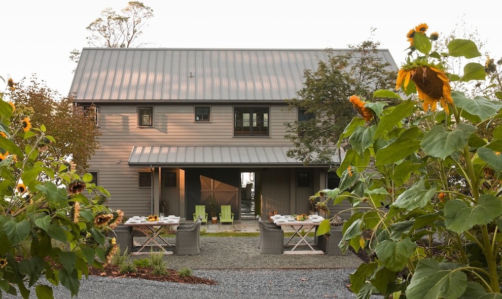 Photo of a mid-sized transitional two-storey exterior in Seattle with wood siding.