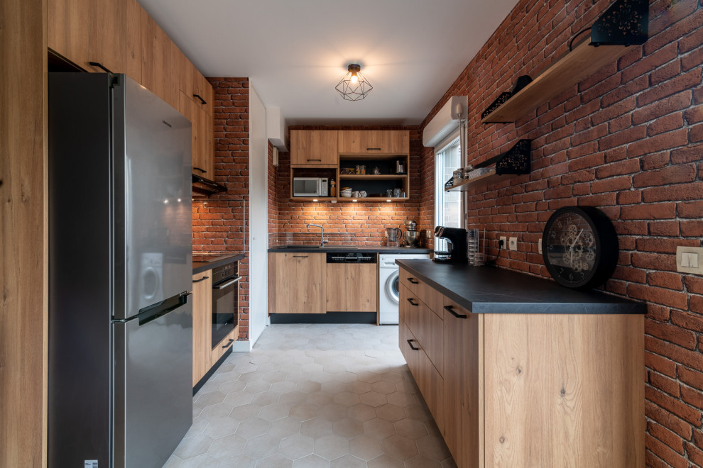 Design ideas for a medium sized industrial l-shaped open plan kitchen in Paris with a submerged sink, light wood cabinets, laminate countertops, multi-coloured splashback, brick splashback, integrated appliances, terracotta flooring, beige floors and grey worktops.