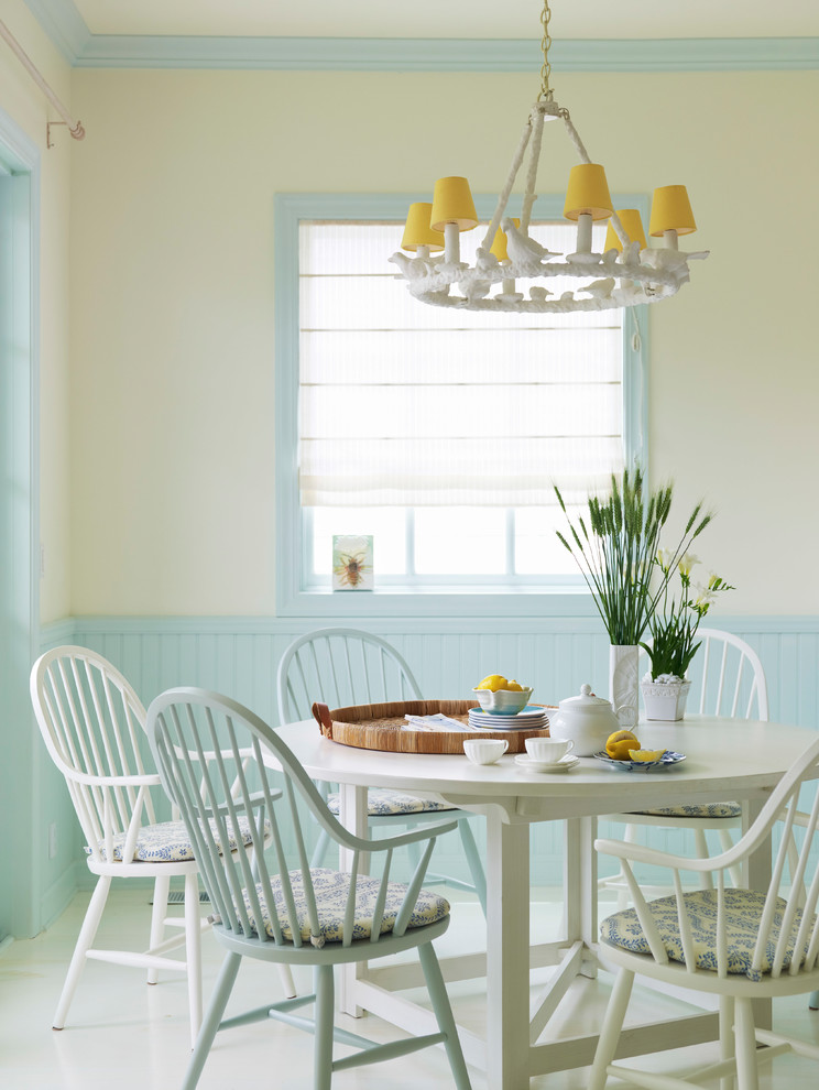 Inspiration for a beach style dining room in Los Angeles with beige walls and white floor.