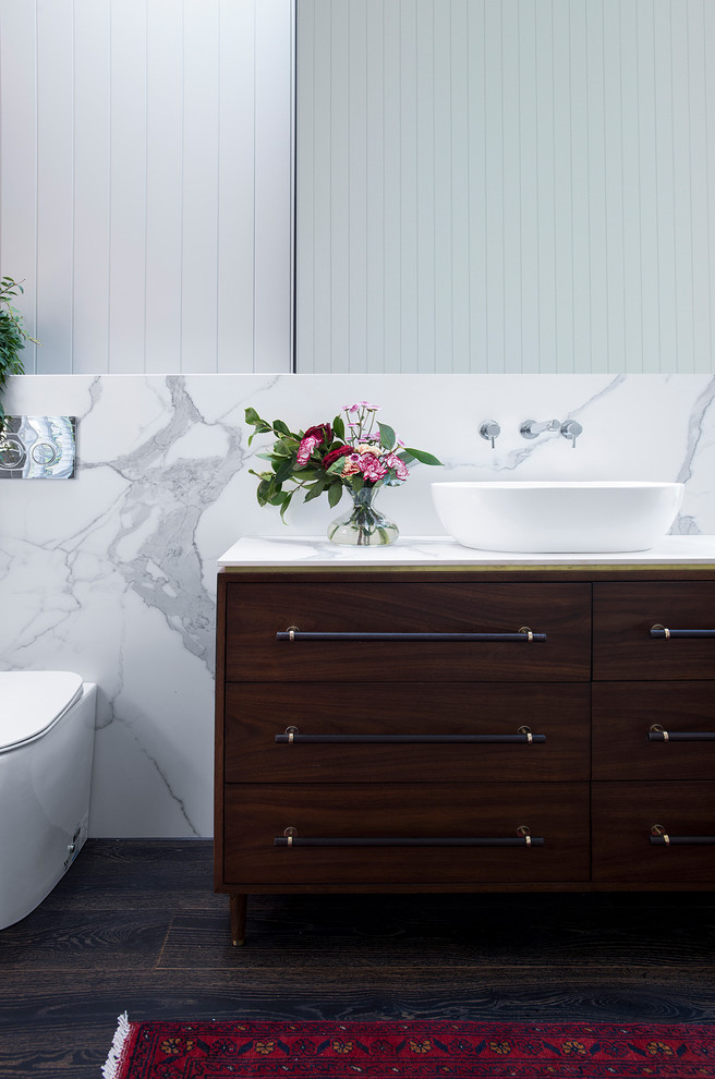This is an example of a modern bathroom in Sydney with white tile, porcelain tile, white walls, brown floor and white benchtops.