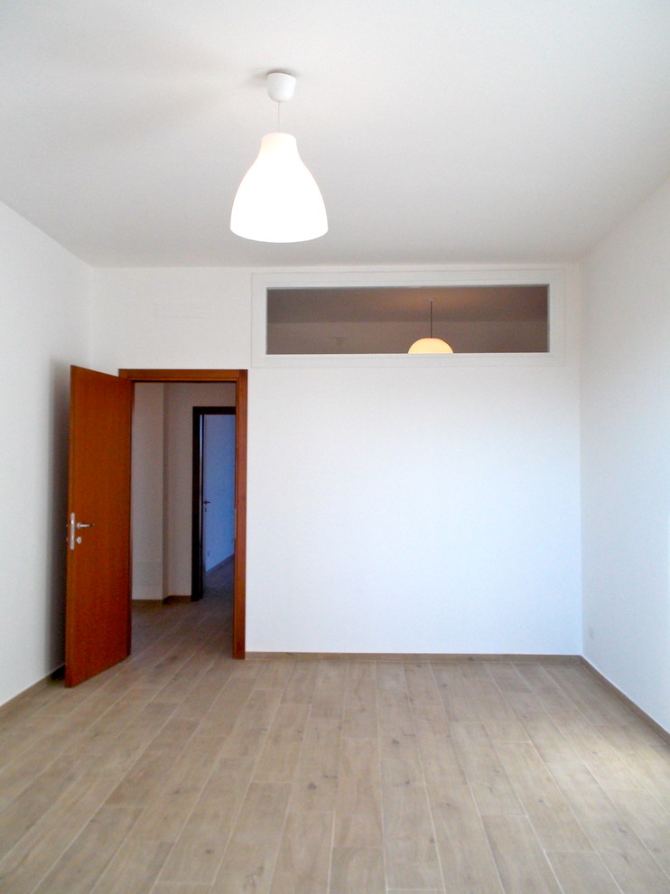 Immagine di uno studio design di medie dimensioni con pareti bianche, pavimento in gres porcellanato e pavimento beige