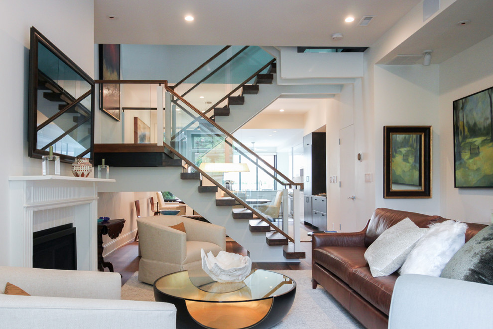 Photo of an expansive contemporary glass floating staircase in DC Metro with open risers and glass railing.