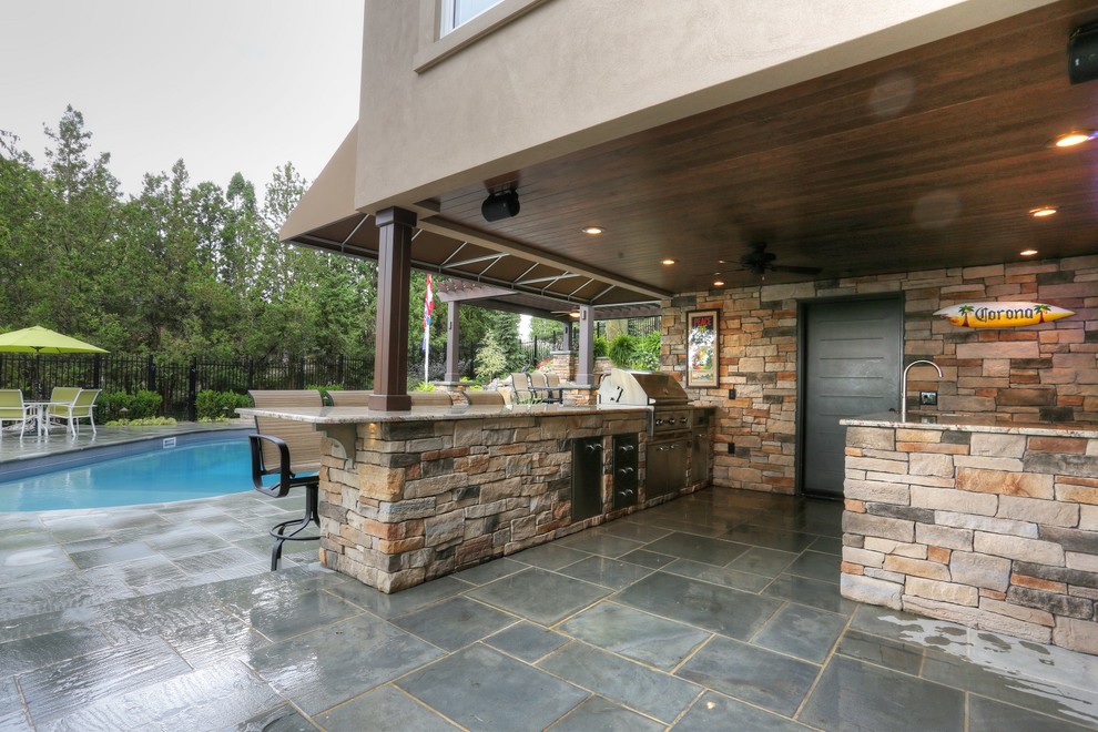 Mid-sized arts and crafts backyard round pool in Toronto with a pool house and natural stone pavers.