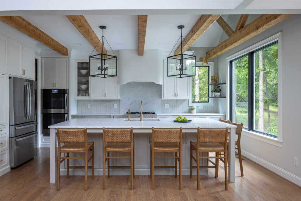 Inspiration for a large transitional medium tone wood floor and exposed beam open concept kitchen remodel in Raleigh with an undermount sink, shaker cabinets, gray cabinets, quartz countertops, gray backsplash, porcelain backsplash, stainless steel appliances, an island and white countertops