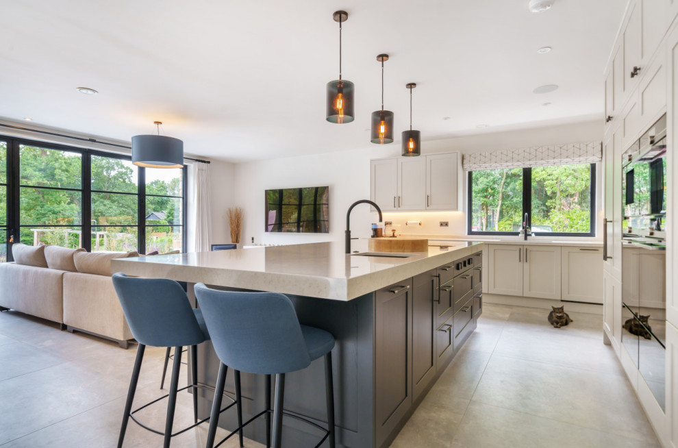 Inspiration for a large classic kitchen in Surrey with shaker cabinets, grey cabinets, an island, white worktops, a submerged sink, quartz worktops and white splashback.