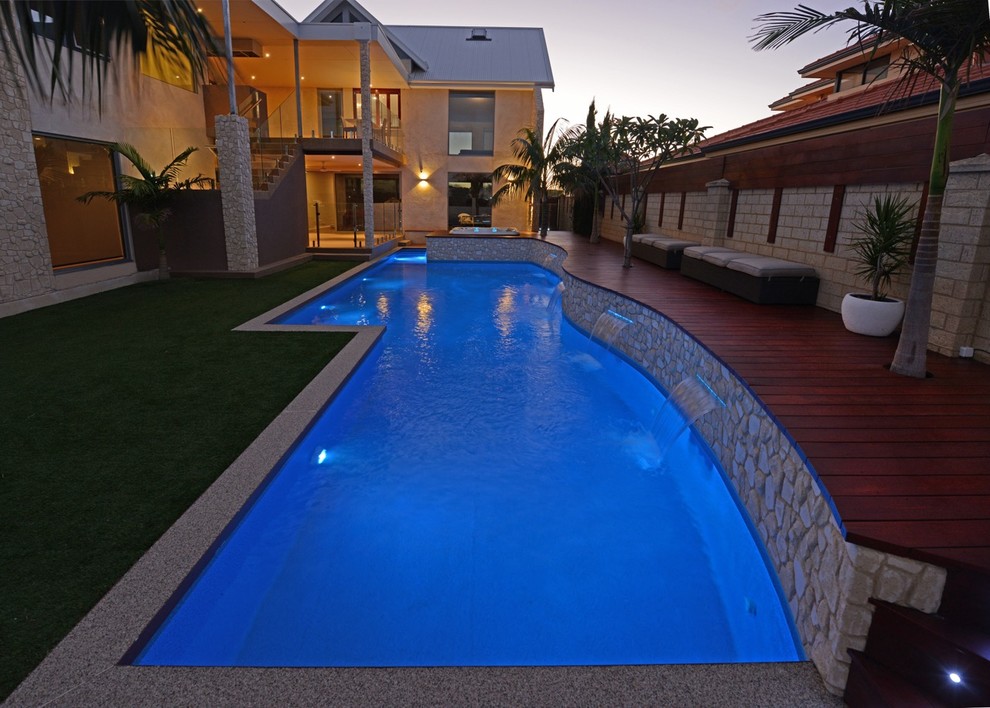 Inspiration for a large contemporary backyard custom-shaped lap pool in Perth with stamped concrete.